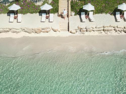 an aerial view of a beach with chairs and umbrellas at Sani Club in Sani Beach