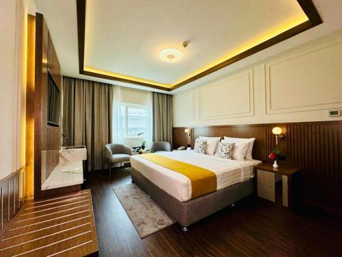 a hotel room with a bed and a television at Fortune Plaza Hotel, Dubai Airport in Dubai