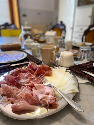 a plate of food with meat and cheese on a table at Villa Ada in Monsummano