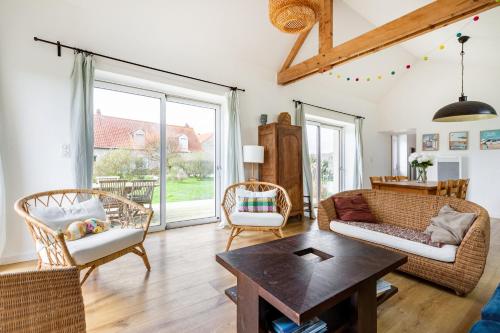 un salon avec un canapé, des chaises et une table dans l'établissement La Grange du Flot, à Tardinghen