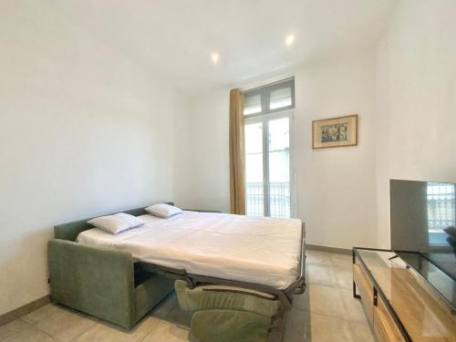 une chambre avec un lit dans une pièce avec une fenêtre dans l'établissement SweetHome Sully, à Nîmes