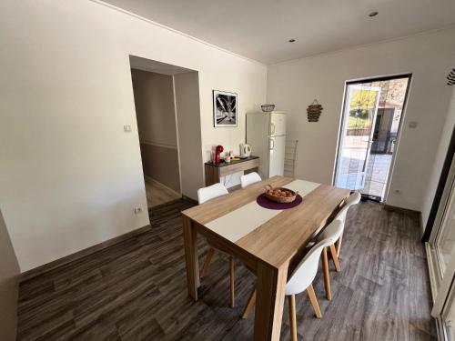 une cuisine et une salle à manger avec une table et des chaises en bois dans l'établissement La ferme de Bournat, à La Répara