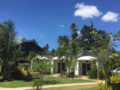 a view of a resort with palm trees at White Chocolate Hills Resort in Zamboanguita