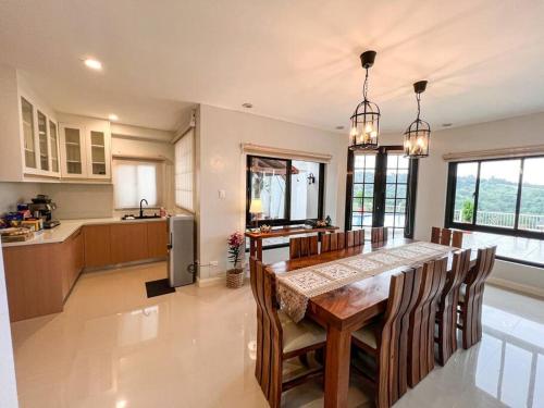 a kitchen with a table and chairs and a kitchen with at Serene Holiday Home Mt Taal View lel in Lemery