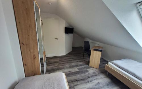 Postel nebo postele na pokoji v ubytování Gästehaus Veldhausen