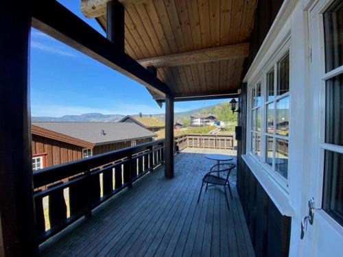 a wooden porch with a bench on a balcony at Hafjell Grenda lejligheder og hytter in Hafjell
