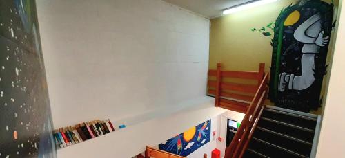 a childs room with a bunk bed and a staircase at Silverfern Backpackers in Auckland