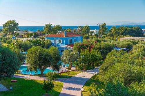 an aerial view of a house with a swimming pool at Filoxenia Apartments & Studios in Theologos