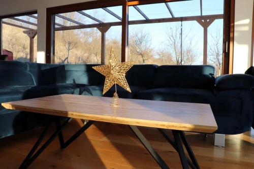 a wooden table with a star on top of it at Aurorae Residence in Recaş