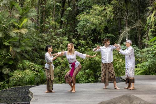 a group of four people dancing on a stage at Sanna Ubud A Pramana Experience in Ubud