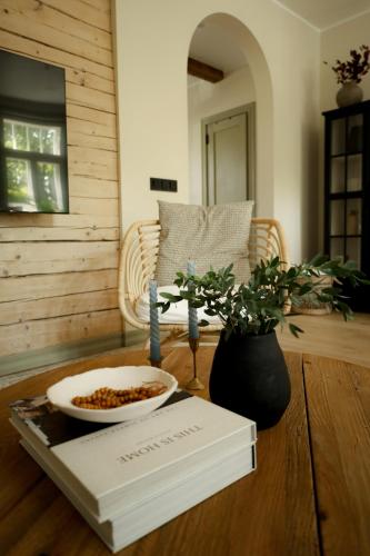 a table with a book and a bowl of food on it at Vaksali Apartment, vaid kahe minuti kaugusel Ugala teatrist in Viljandi