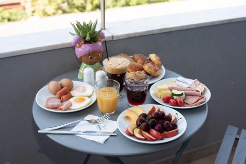 a table with plates of breakfast foods and drinks at White Luxury in Thessaloniki