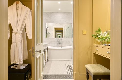 a bathroom with a bath tub and a sink at Ballynahinch Castle Hotel in Ballynahinch