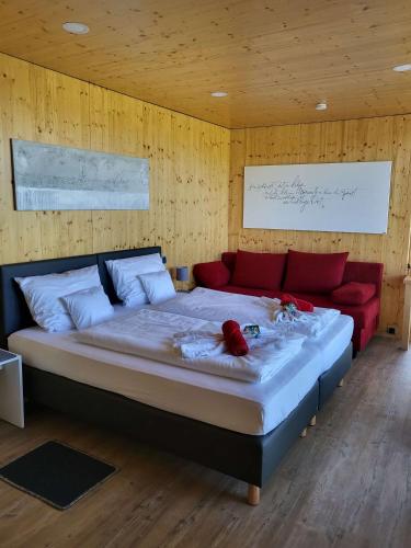 a bedroom with a bed and a red couch at mein kleinDOMIZIL Mittenaar in Mittenaar