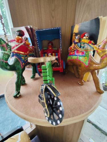 a wooden table with toy figurines on top of it at Sri Murugan Beach Paradise Hotel in Mahabalipuram