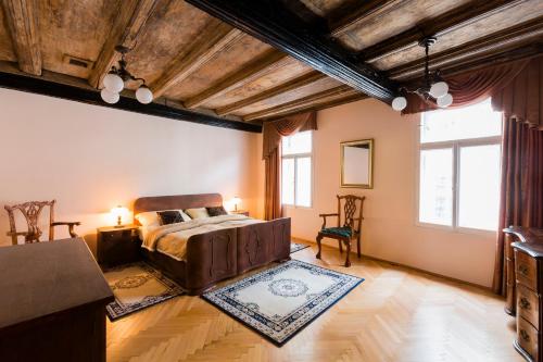 a bedroom with a bed and a large window at Apartments U Krále Brabantského in Prague