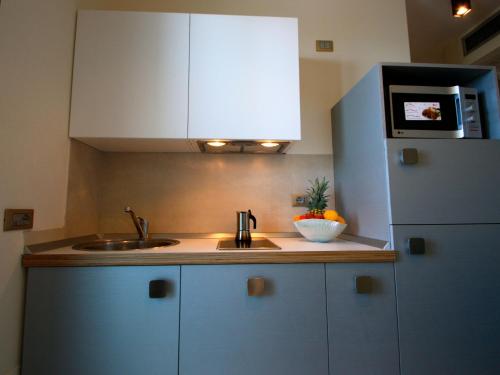 a kitchen with a sink and a refrigerator at Hotel & Residence Cavalluccio Marino in Rimini