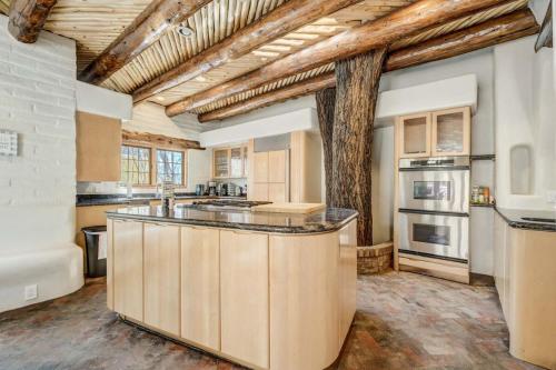 a kitchen with a large center island in a room at Adobe del Sol - House & Cottage by The Broadmoor in Colorado Springs