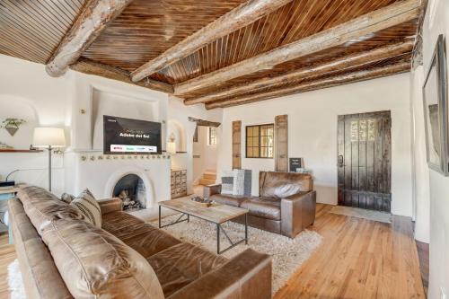 a living room with a couch and a fireplace at Adobe del Sol - House & Cottage by The Broadmoor in Colorado Springs