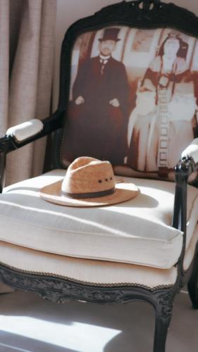 a hat sitting on top of a chair with towels at COCCOLOBA in Holbox Island