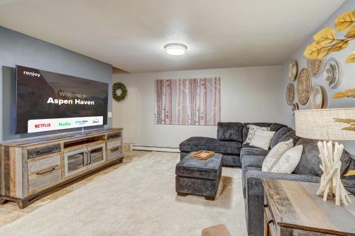 a living room with a couch and a flat screen tv at Aspen Haven - Mountain Retreat BBQ Scenic Views in Divide