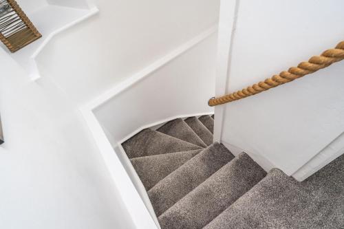 a winding staircase in a house at The Old Coastguard Tower Buncrana in Buncrana