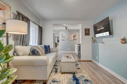 a living room with a couch and a flat screen tv at Euro Villa - Walkable Location Scenic Views in Colorado Springs