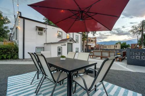 a table and chairs with a red umbrella on a patio at Pikes Escape - Downtown Workcation 4K Roku in Colorado Springs