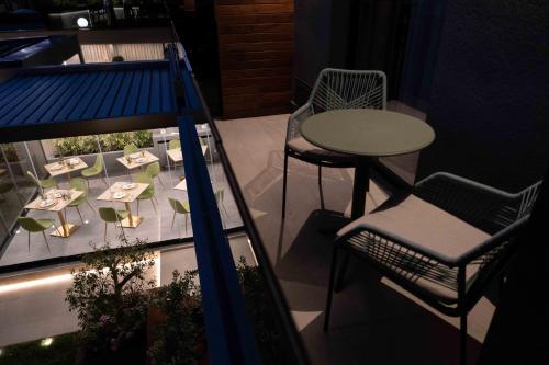 a balcony with a table and chairs and a table and chair at Divina Charme in Mascalucia