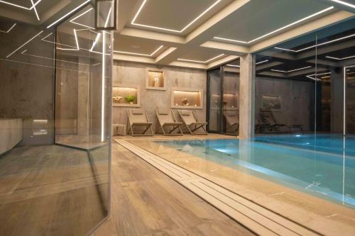 a pool in a hotel with chairs and a swimming pool at Divina Charme in Mascalucia