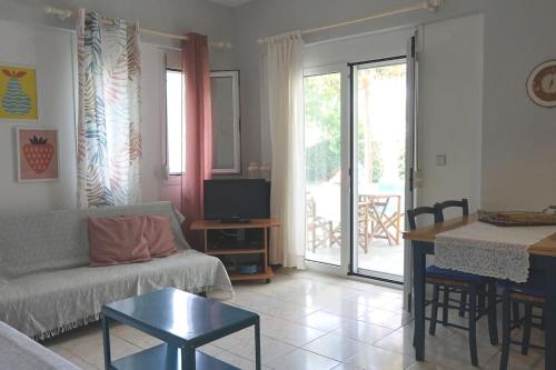 a living room with a couch and a table at Filippos house in Nea Fokaia in Nea Fokea