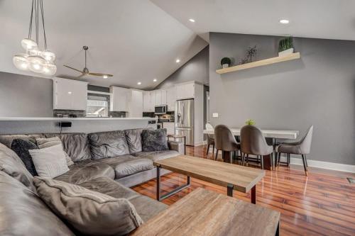 a living room with a couch and a table at Redwood Haus Premier Spot Hot Tub BBQ in Colorado Springs