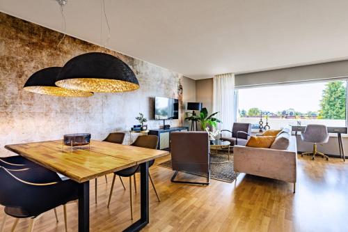 a living room with a wooden table and chairs at Hello & Welcome Apartment in Odenthal