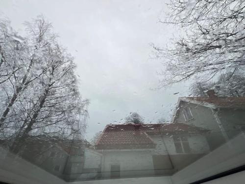 a house with snow on the roof and trees at Budget apartment - Snorres Gate 4b - apt 3 in Tønsberg