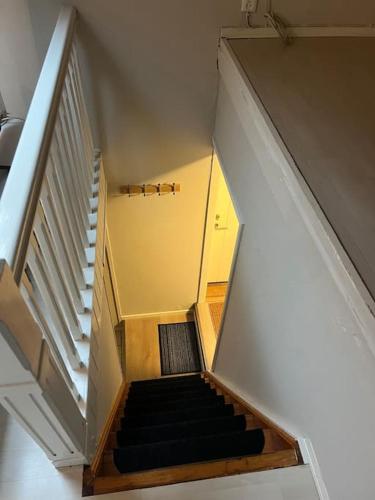 a staircase in a house with a stair case at Budget apartment - Snorres Gate 4b - apt 3 in Tønsberg