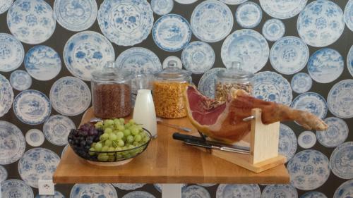 a table with jars of food and a bowl of fruit at Le Nouvel Hôtel in Oyonnax