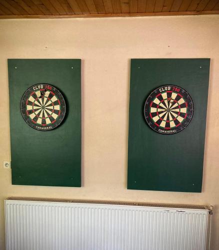 two dart boards on a wall with a dart board at Zlatý páv in Moldava nad Bodvou