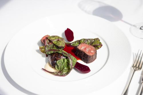 a plate of food with meat and vegetables on a table at Ballynahinch Castle Hotel in Ballynahinch