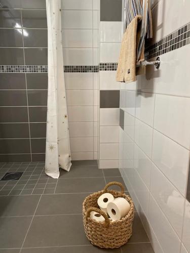 a bathroom with a basket of toilet paper on the floor at Sälfjällstorget in Sälen