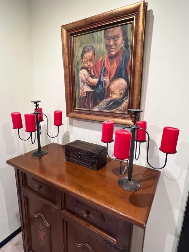 a painting of a woman with a child and red candles at Budahome im Schwarzwald in Neuenbürg