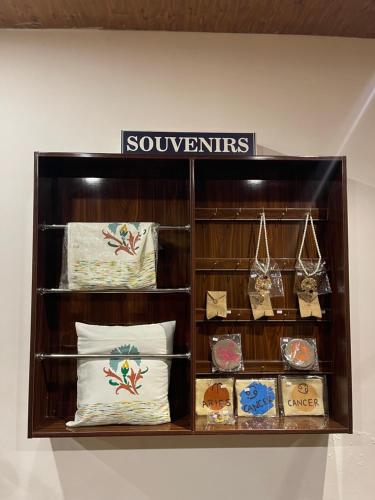 a shelf with pillows and other items on it at Hotel Oban in Lahore
