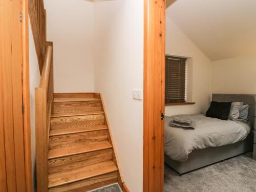 a bedroom with a bunk bed and a staircase at Low Fold Cottage in Penrith