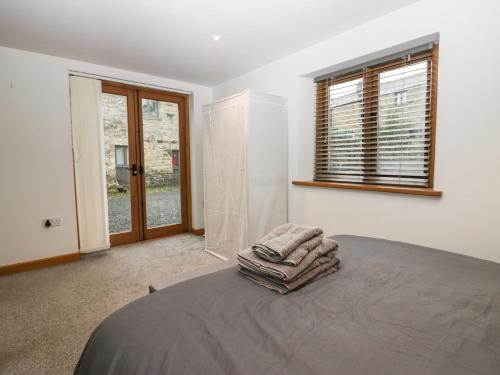 a bedroom with a bed with two towels on it at Low Fold Cottage in Penrith