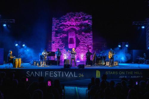 a group of people on a stage at night at Porto Sani in Sani Beach