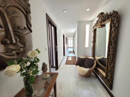 a living room with a mirror and a couch at Penthouse Sabina in Torrevieja