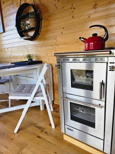 a kitchen with a stove with a tea kettle on it at Behagliches OFFGRID Tiny House - Escape to Nature in Sankt Pölten