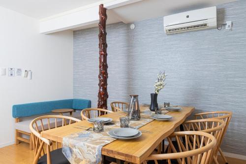 a dining room with a wooden table and chairs at Zen Home AKABANE in Tokyo