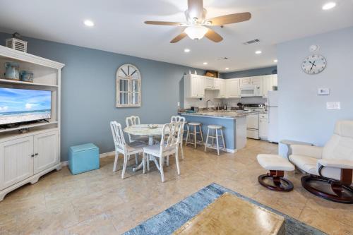 a dining room and kitchen with a table and chairs at Grand Caribbean East 207 By Pkrm in Pensacola