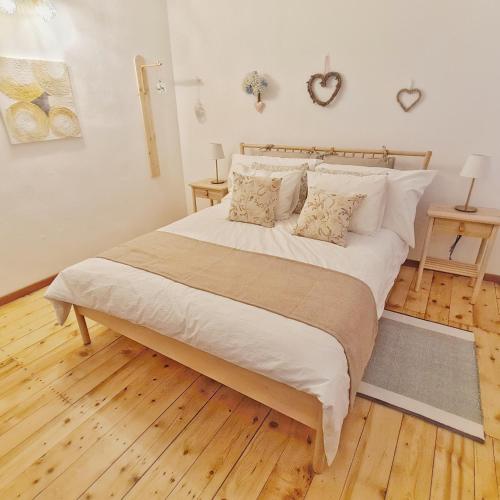 a large bed with white sheets and pillows in a bedroom at Casa Bella Locarno in Locarno