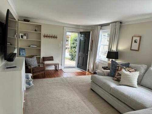 a living room with a couch and a table at Newly Renovated Carriage House in Hillsborough